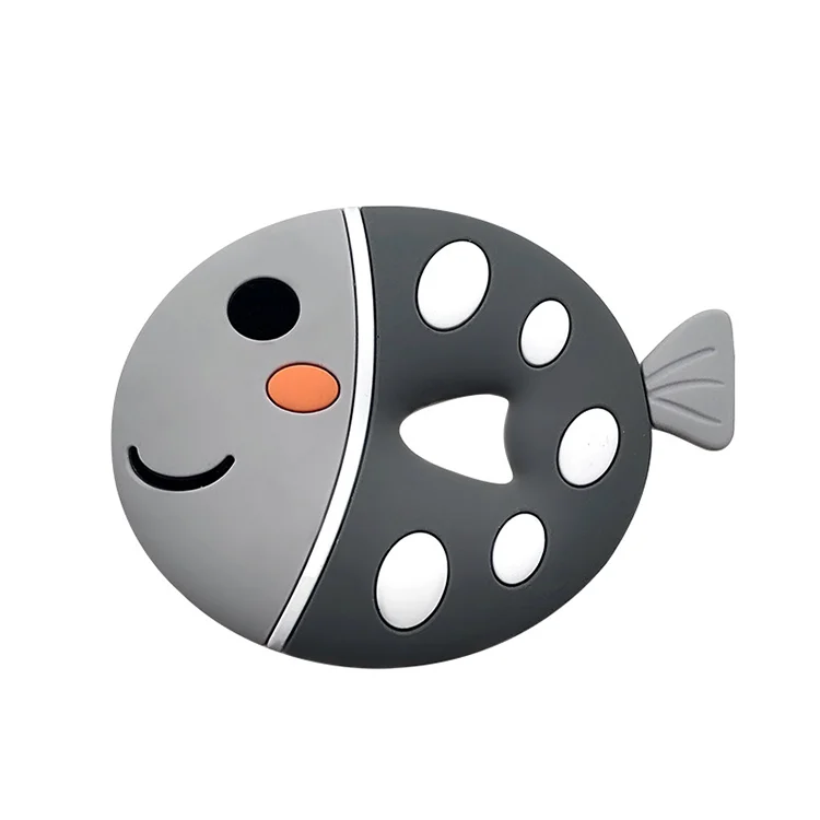 Fish-shaped silicone teether with beads, green colour, close-up of texture