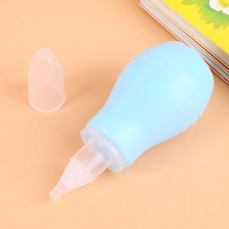 Pink baby nasal aspirator held in hand, showing the pump mechanism