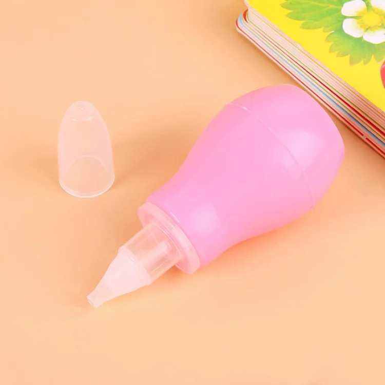 Yellow baby nasal aspirator with nozzle detached, showing internal parts