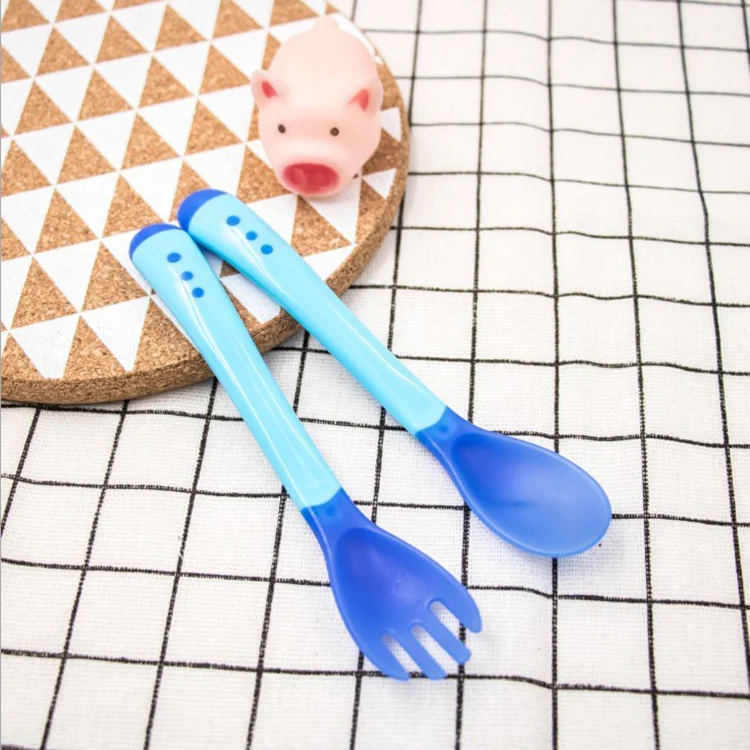 Baby spoon and fork set with soft TPE tips, showing the ergonomic handle