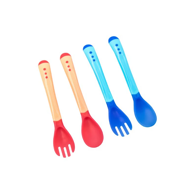 Pink baby spoon and fork set with soft TPE tips, standing upright in PP box