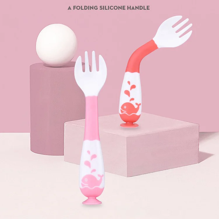 Spoon and fork set in use by a toddler, showing the bendable shaft and grip
