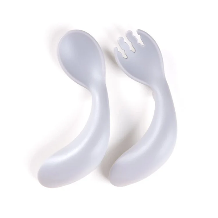 Set of fork and spoon laid flat on a white surface