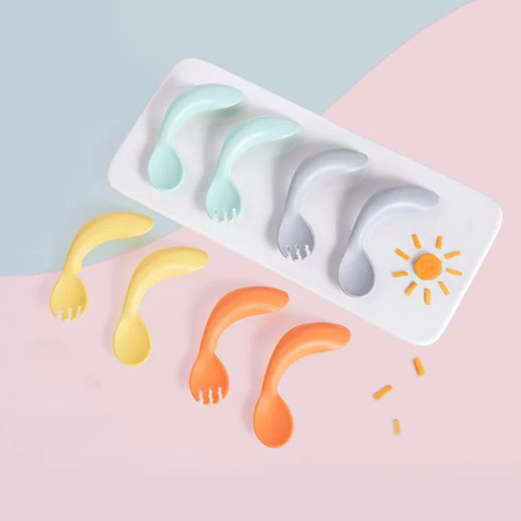 Spoon and fork in use, showing grip and feeding motion