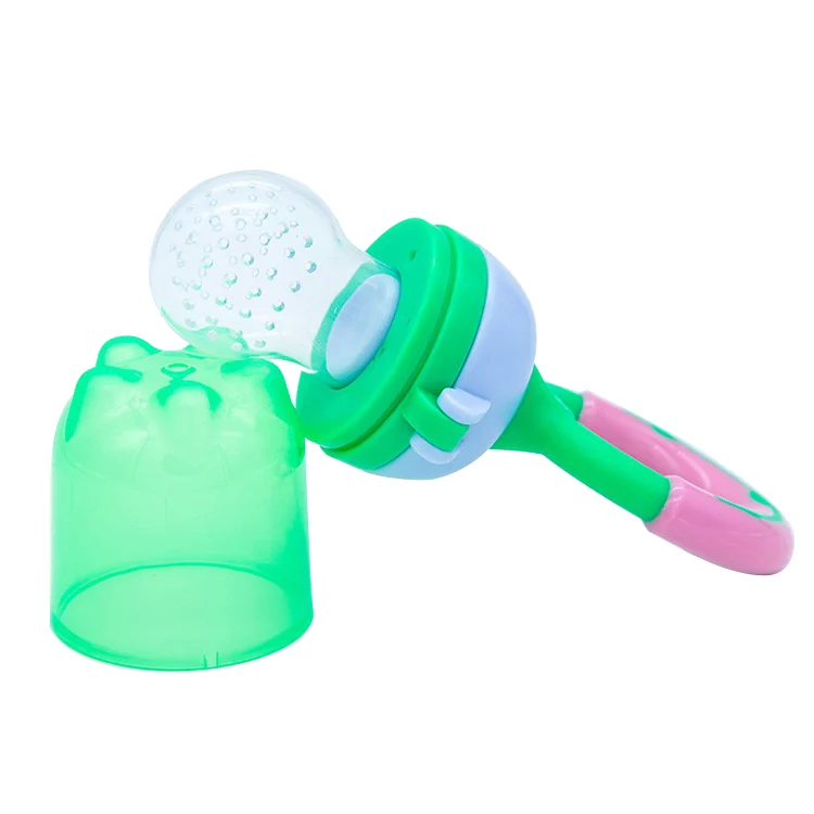 Pacifier in use with a baby feeding on pureed fruit, showing the mesh filled