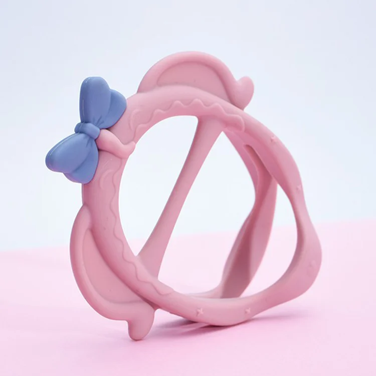 Pink silicone teething bracelet shaped like an elephant with a bowknot and hat