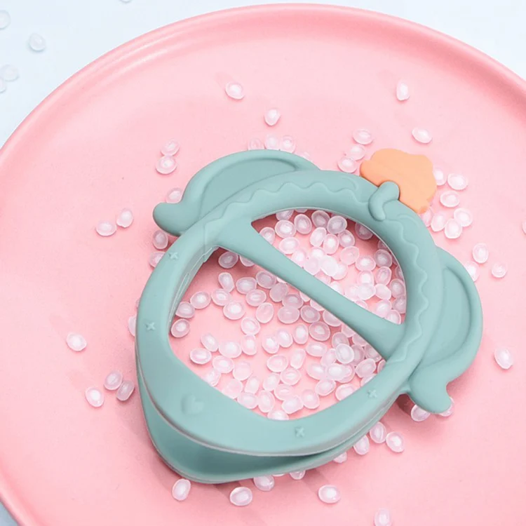 Side view of the pink teething bracelet showing the soft silicone texture