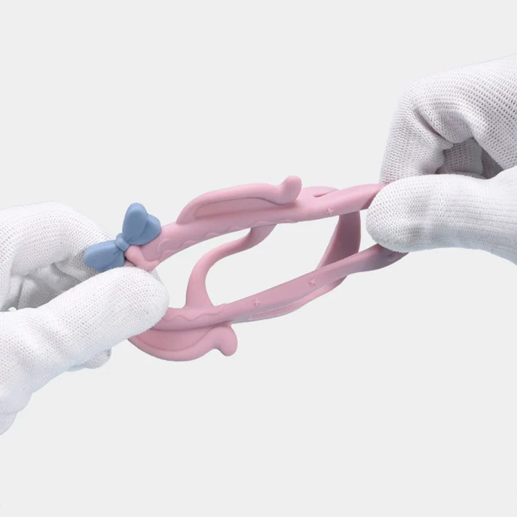 Teething bracelet laid flat with the bowknot and hat detail visible