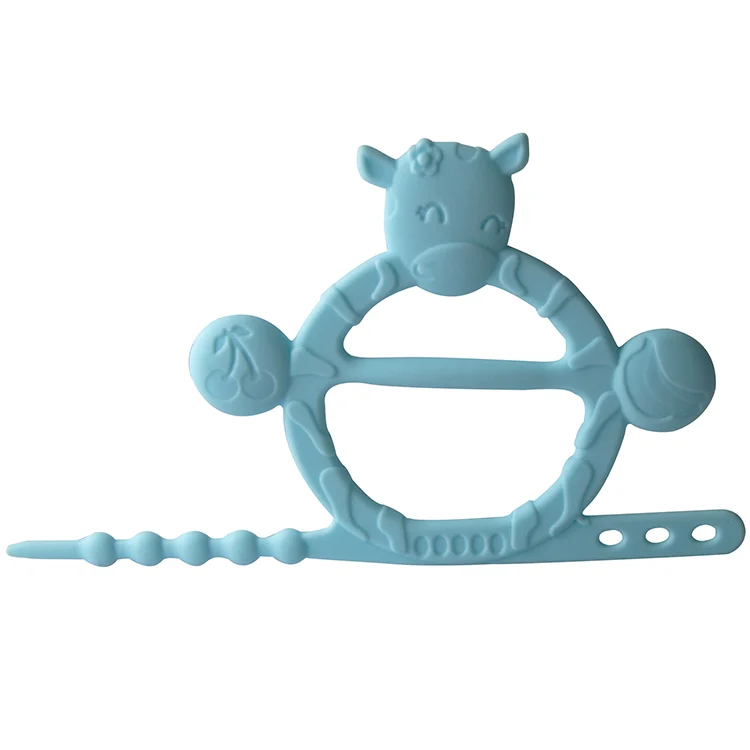 Cow-shaped teething bracelet in green, close-up of textured ridges and soft silicone