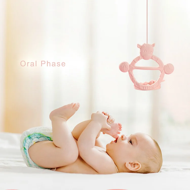 Cow-shaped teething bracelet in blue, side view showing thickness and ergonomics