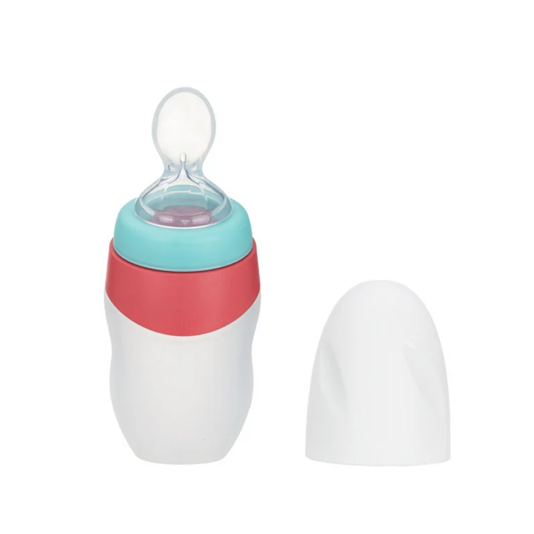 Grey 90ml silicone feeding bottle with spoon and cap in use