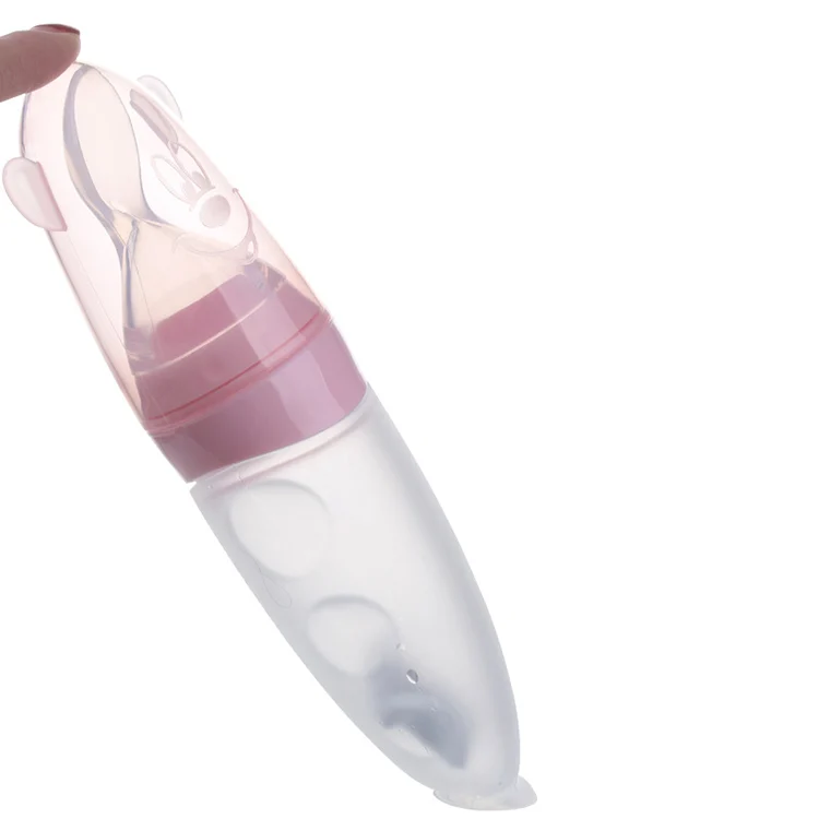 Close-up of the spoon tip and soft silicone body, with food being squeezed out