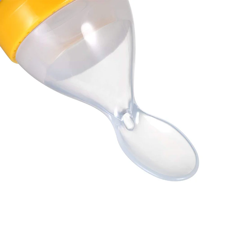 Baby feeding bottle with spoon head and cover, standing upright