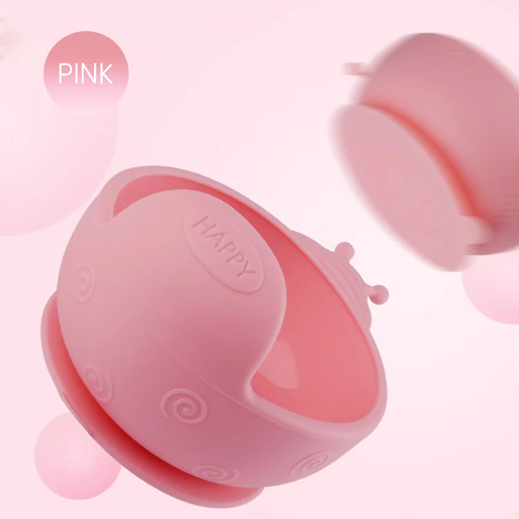 Green snail-shaped silicone feeding bowl with lid removed, showing interior
