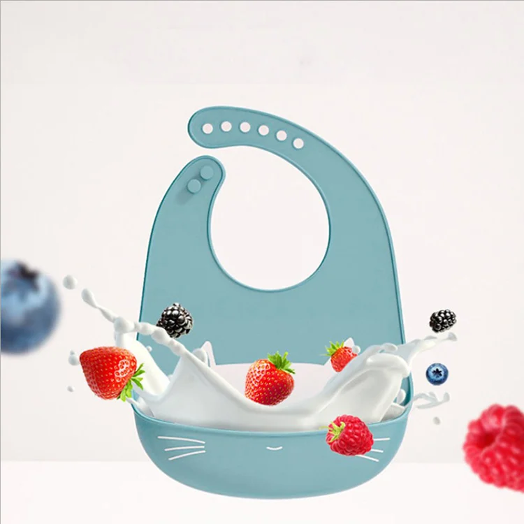 Silicone baby bib in yellow, standing upright with the pocket open