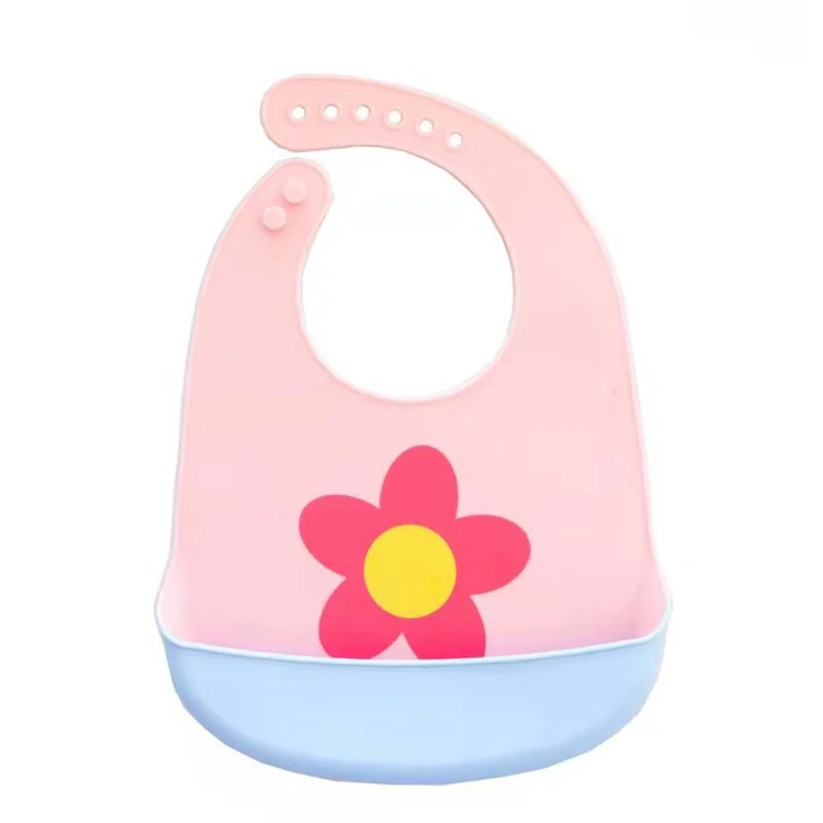 White silicone baby bib with adjustable neck buttons, open pocket showing spill-proof design