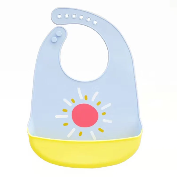 White silicone baby bib rolled up for compact storage in a nappy bag