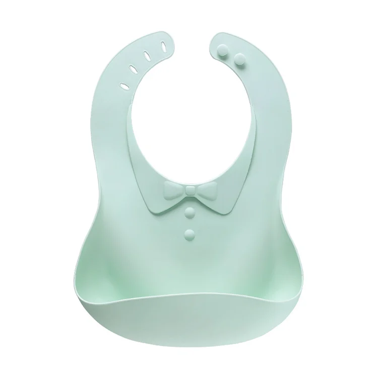 Green foldable silicone baby bib rolled up for compact storage