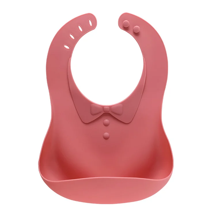 Pink foldable silicone baby bib with bow-tie collar, standing upright