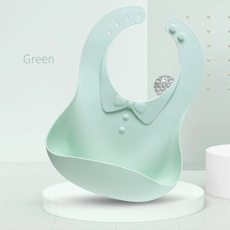 Close-up of the bow-tie button fastener on a foldable silicone baby bib