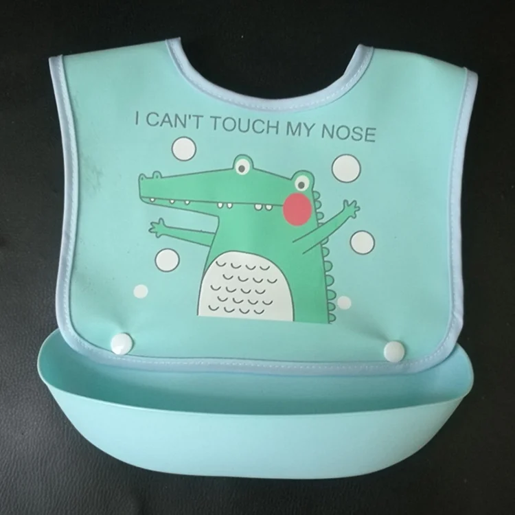 Pink baby bib with detachable food tray, laid flat