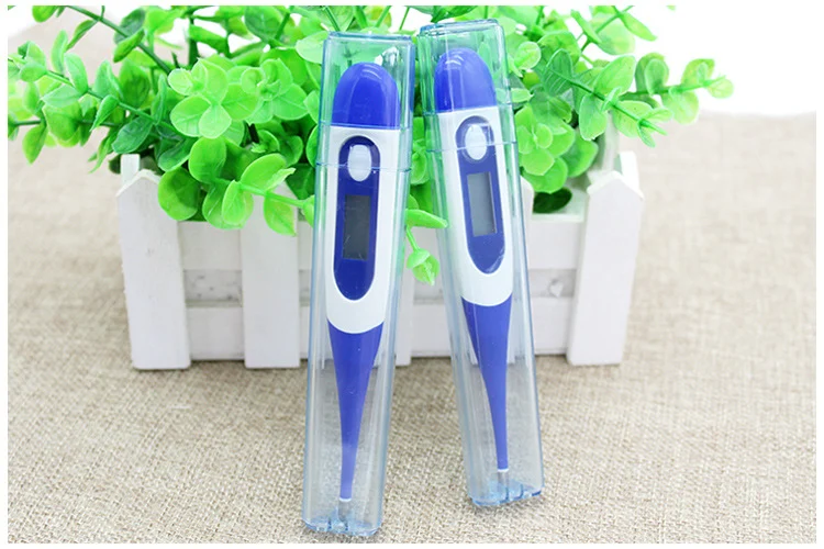 Digital thermometer with the display and button visible, close-up