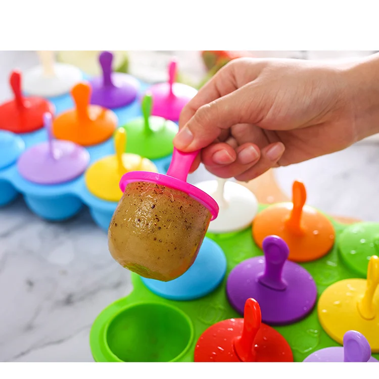 Silicone mold filled with baby food cubes, placed in a freezer