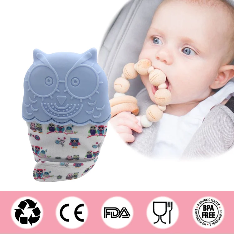 Green silicone teething glove with sound film, close-up of the sound film area