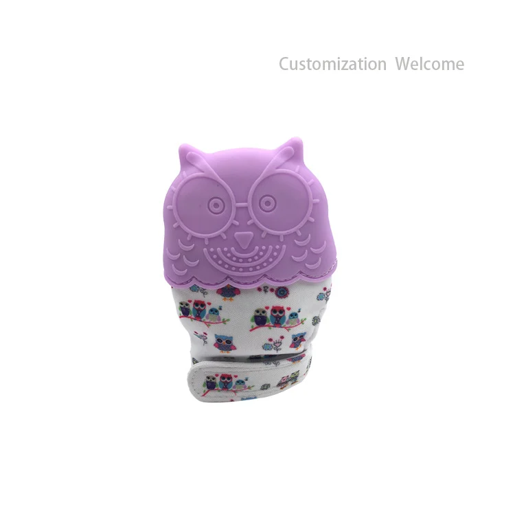 Silicone teething glove with sound film, placed on a white surface with a clean background