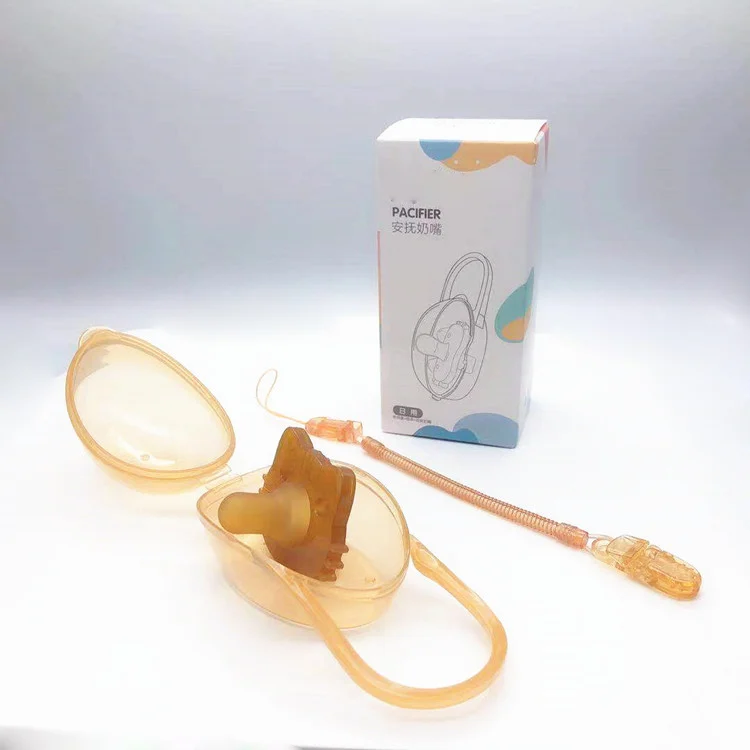 Side view of the pacifier showing the clip and nipple thickness