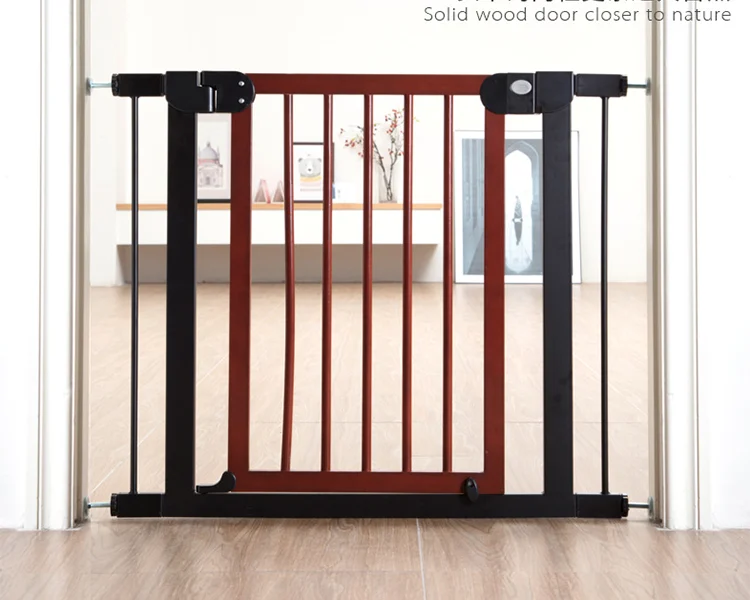 Wooden baby gate open, showing pressure-mounted side panels and auto-close feature