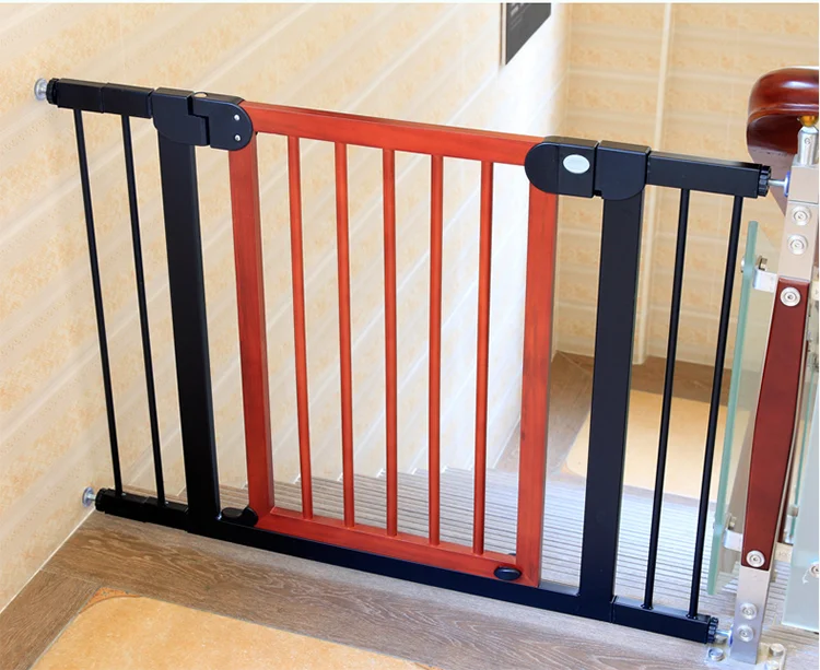 Brown and red wooden baby safety gate with retractable mechanism, closed