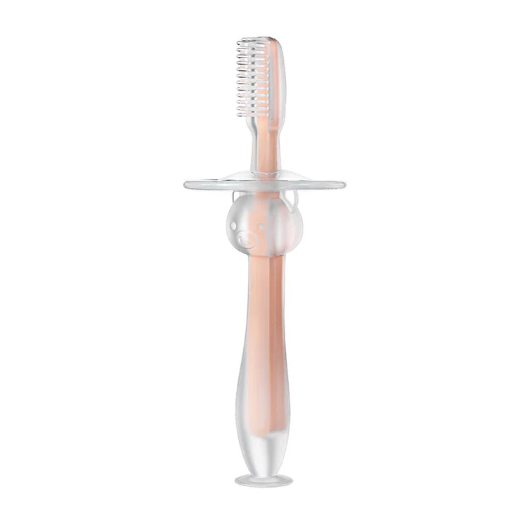 Pink silicone baby toothbrush with pig-shaped handle and suction cup base