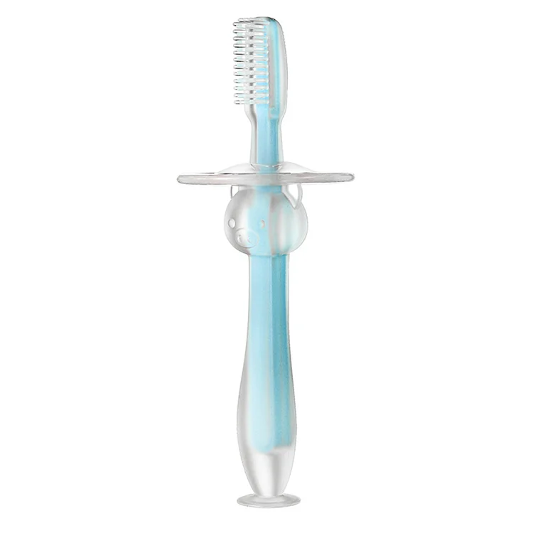 Yellow baby toothbrush standing upright on a flat surface