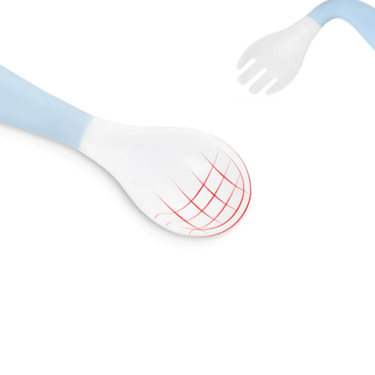 Baby spoon and fork set laid flat on a table, handle bent left