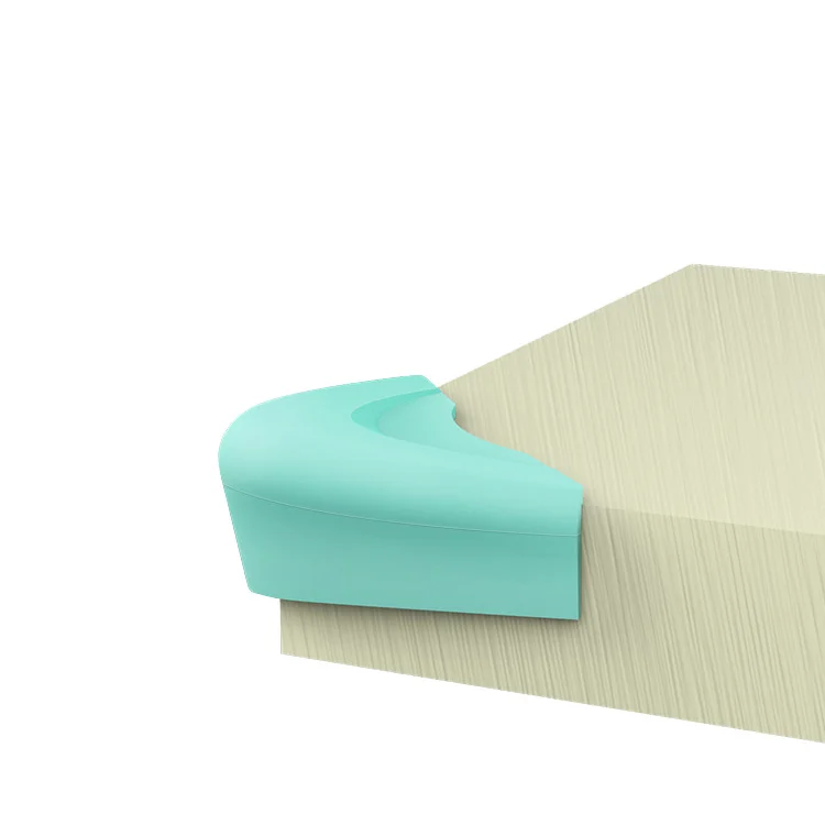 Green silicone corner guard on a glass table edge