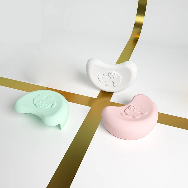 Elephant-shaped silicone corner guard applied to a sharp corner of a ceramic table
