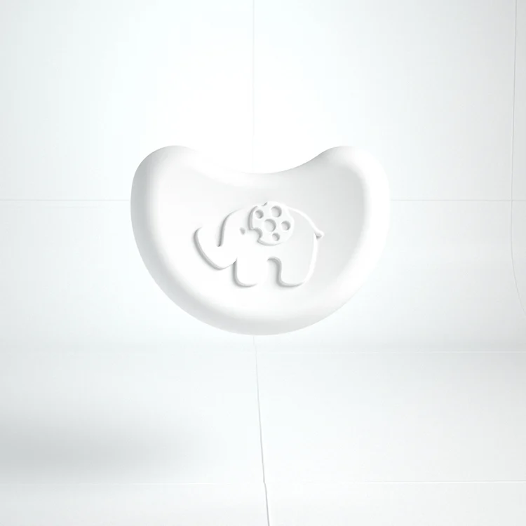 Two yellow elephant-shaped silicone corner protectors on a metal cabinet edge