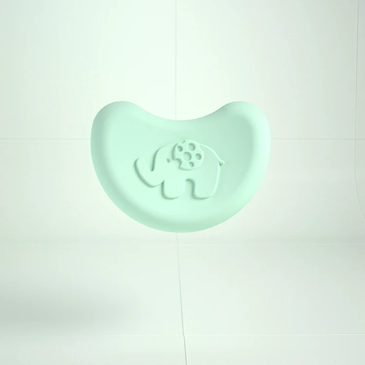 Two grey elephant-shaped silicone corner protectors on a glass coffee table