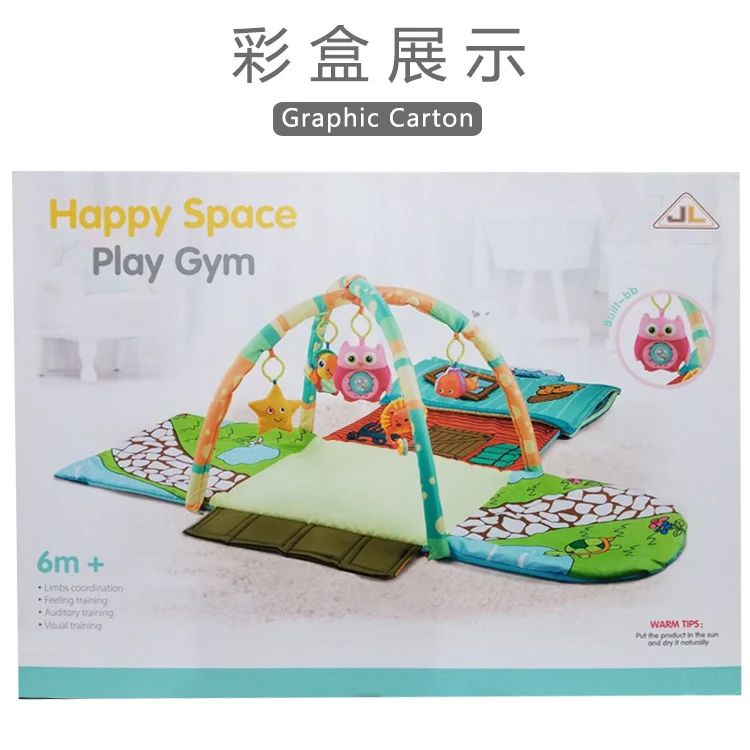 Baby gym mat with a baby lying on it, reaching for the hanging toys