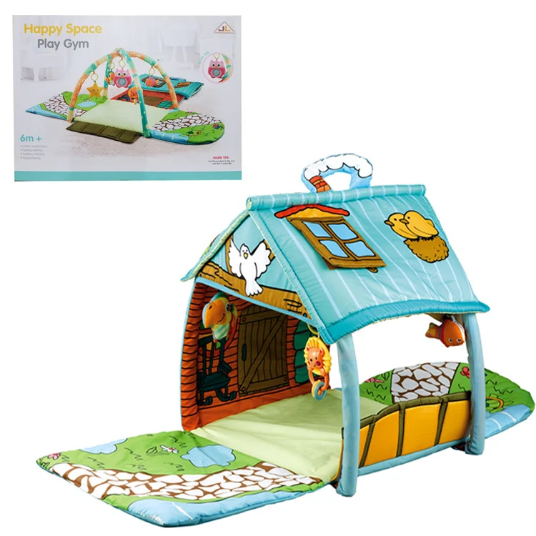 Baby gym mat viewed from the side, showing the house structure and hanging toys