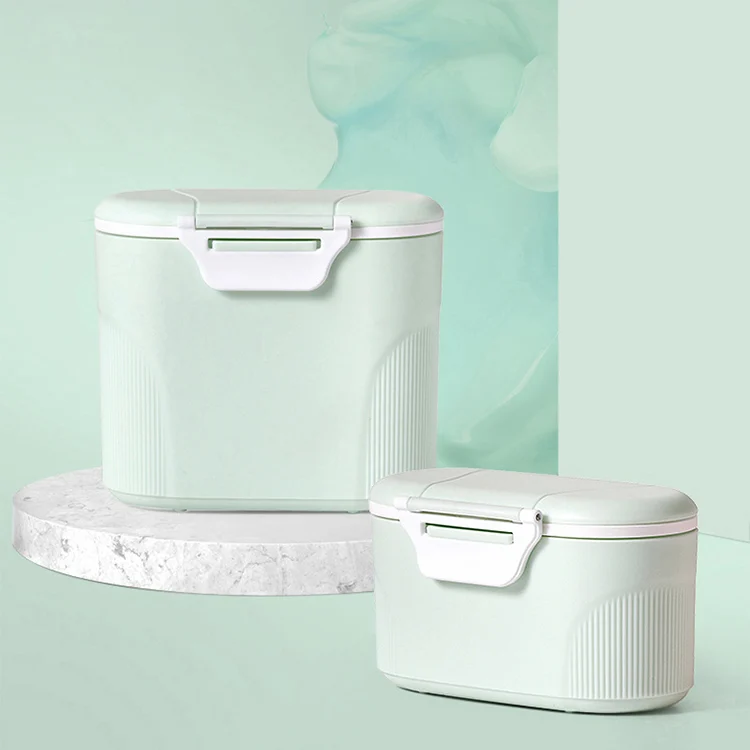 Pink 600ml milk powder container standing upright with scoop inside