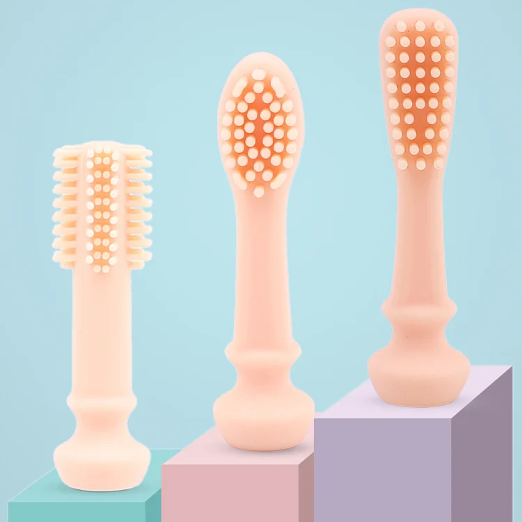 Grey silicone toothbrush standing upright on a table with base adhered