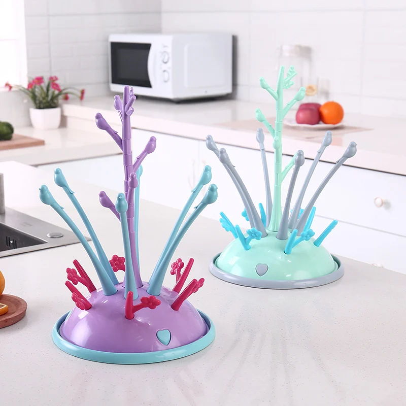 Baby bottle drying rack with branches holding bottles and teats, water tray visible