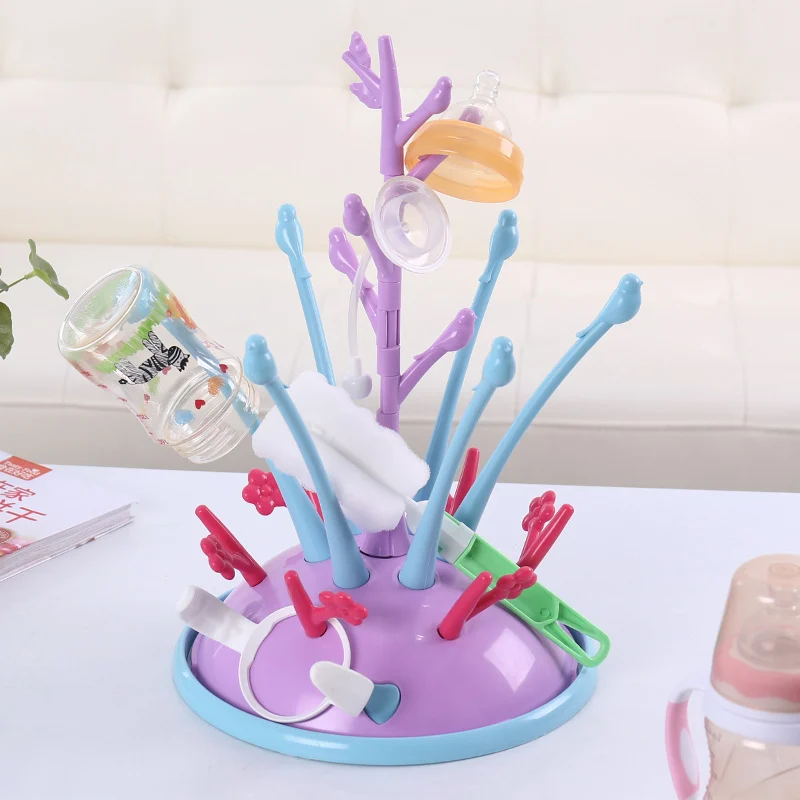 Drying rack with bottles and pump parts placed on branches, showing full capacity
