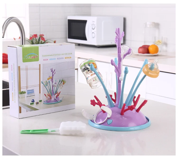 Drying rack with the bottle brush in use, cleaning a bottle neck