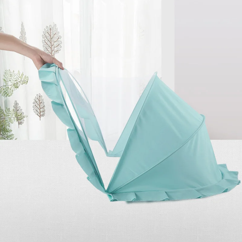 Baby mosquito net canopy in use at a park, folded and stored in a backpack