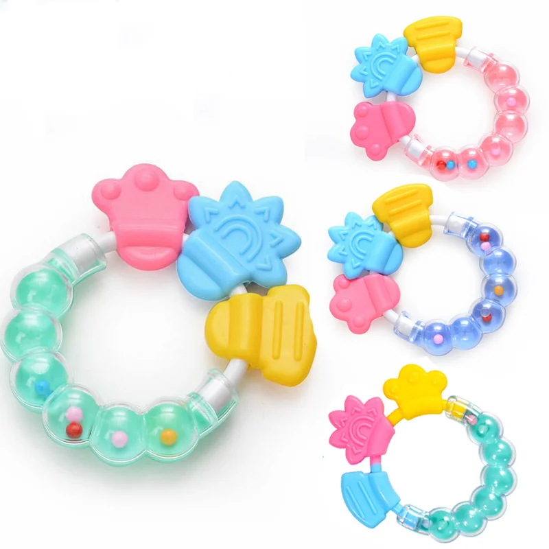Infant rattle teether with multiple colours and textures, held in hand