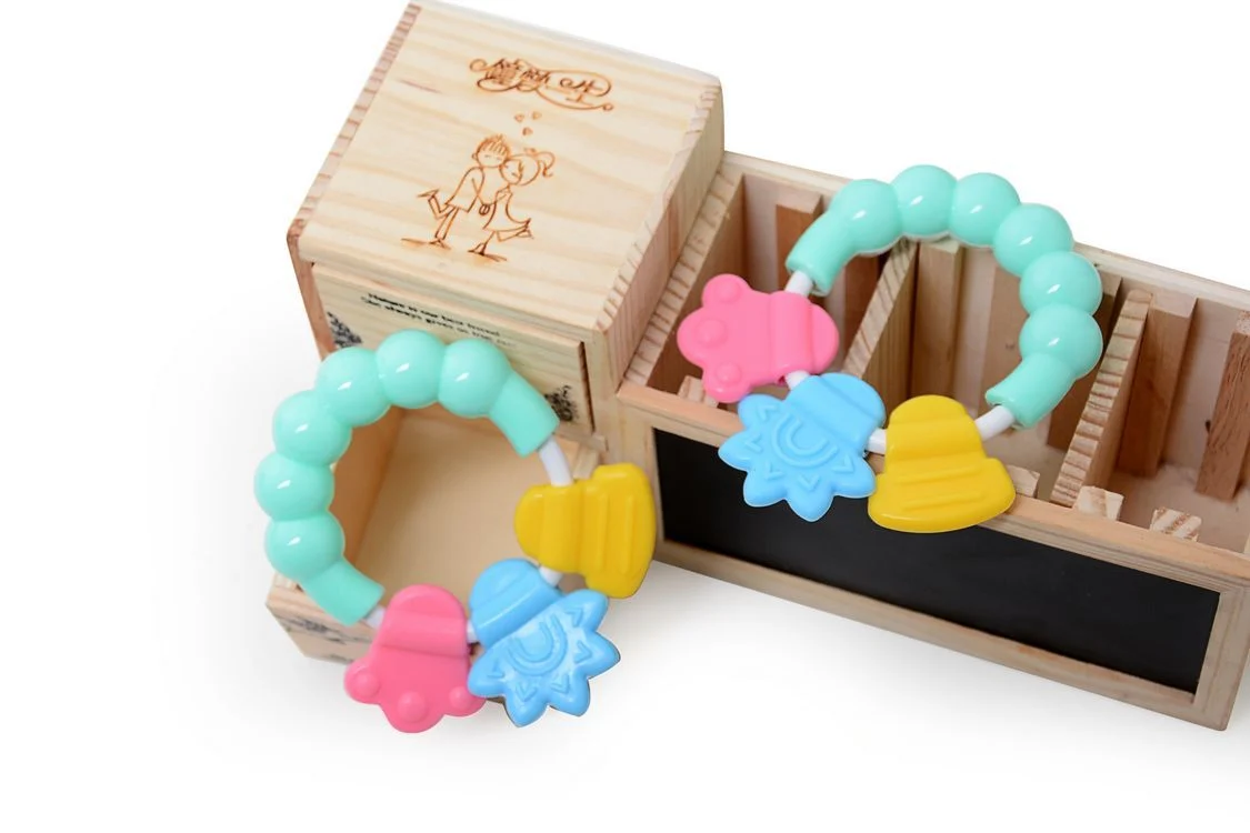 Infant rattle teether with close-up of silicone teething surface