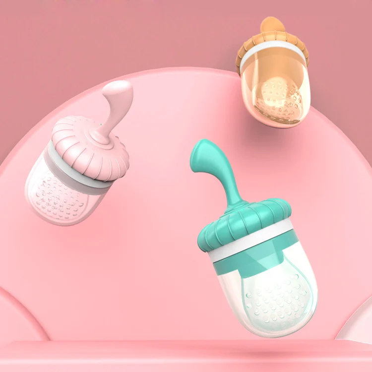 Pink little pumpkin-shaped silicone baby food feeder pacifier with attached teat